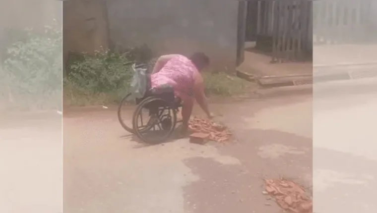 Cadeirante desiste de esperar prefeitura e tapa buracos sozinha